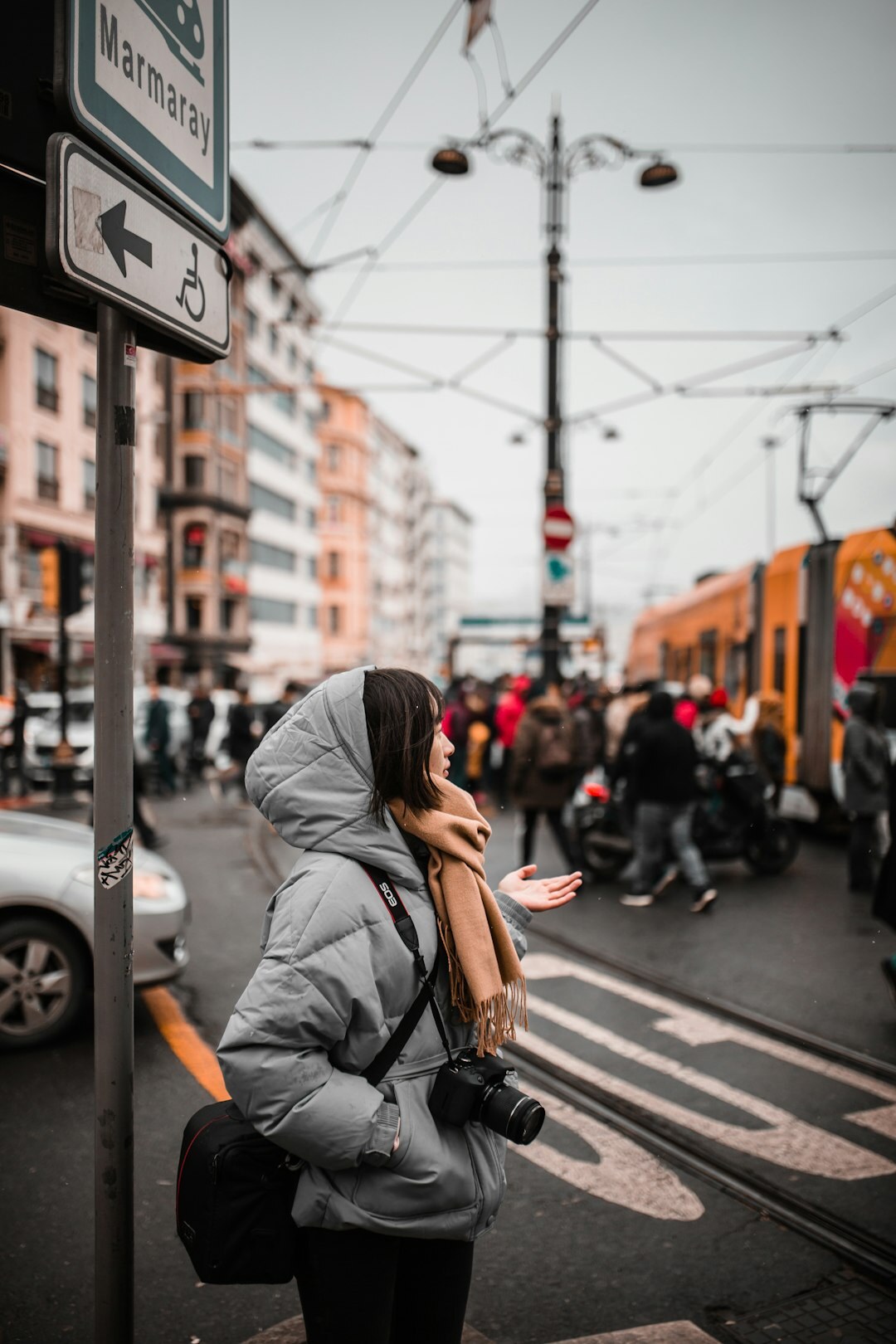 Photojournalist capturing a street scene with a camera